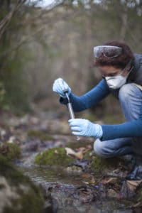 Woman Environmental Researcher Taking a Water Sample